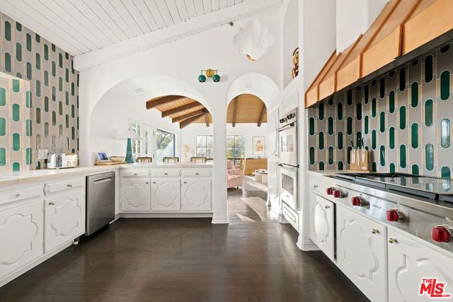 a stove top oven sitting inside of a kitchen
