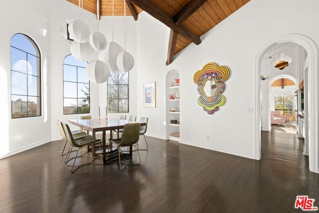 a living room with furniture a flat screen tv and balcony