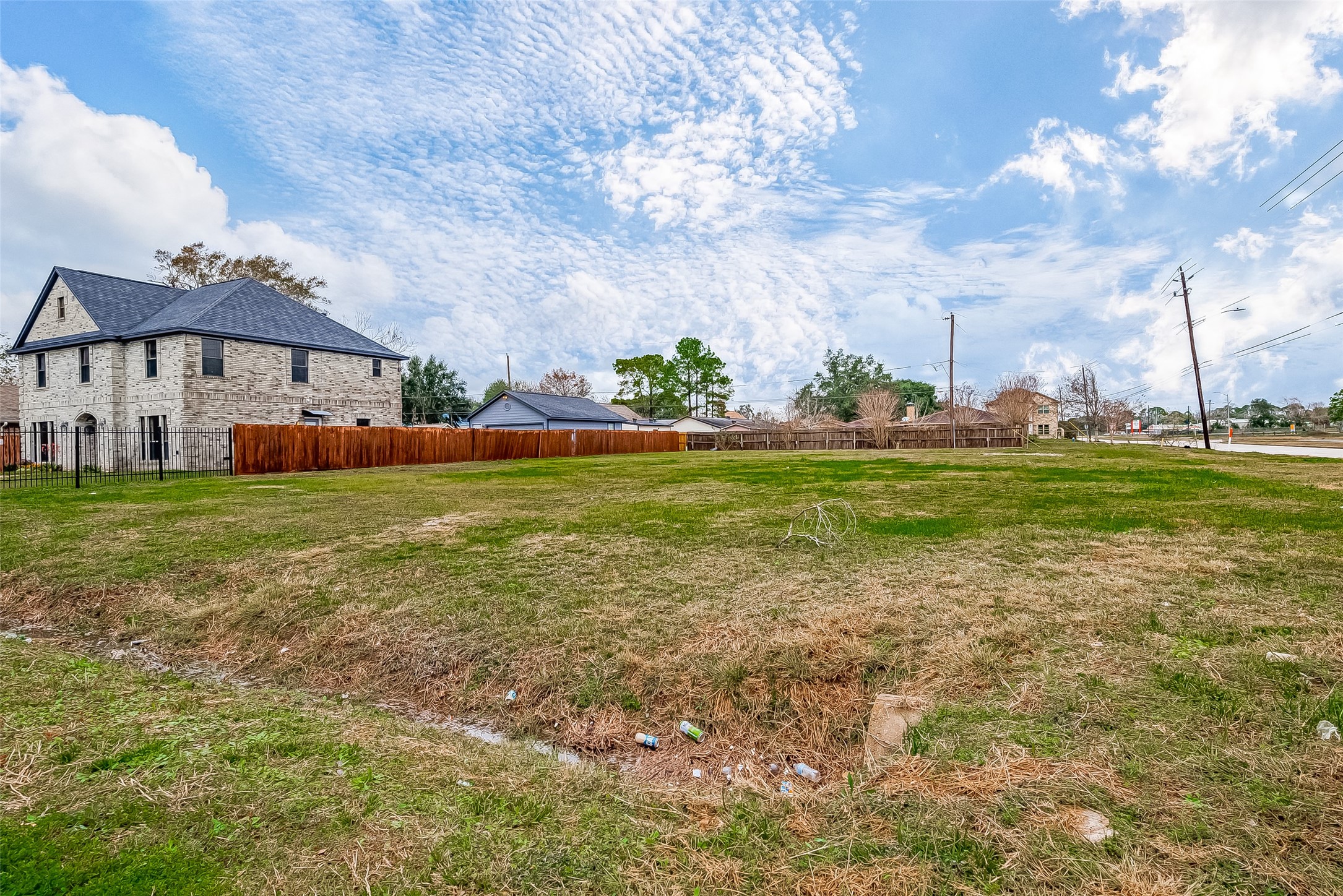 0 Wetherby Lane Houston, TX 77075 - Photo 1 of 11 a view of a house with a big yard and large trees
