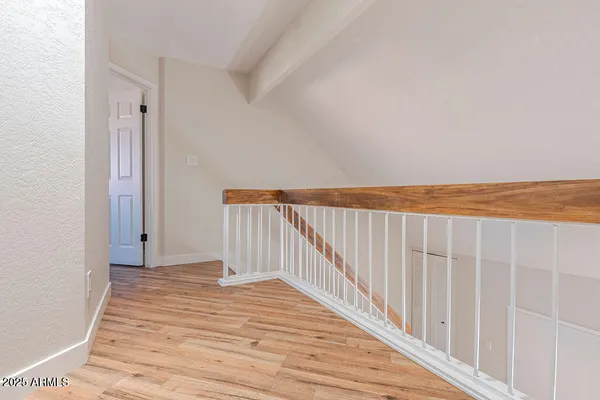 a view of a room with wooden floor