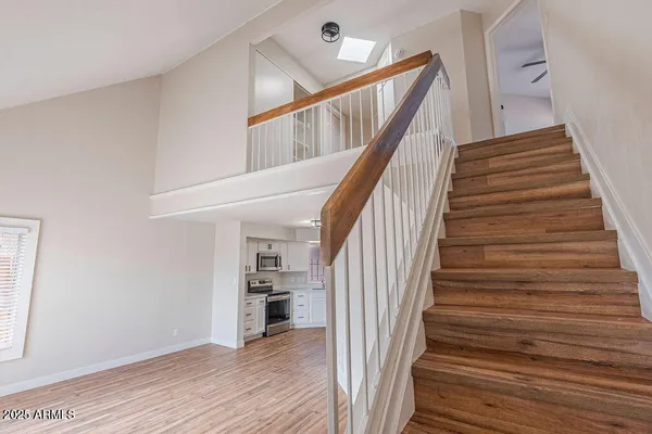 a view of entryway and hall with wooden floor