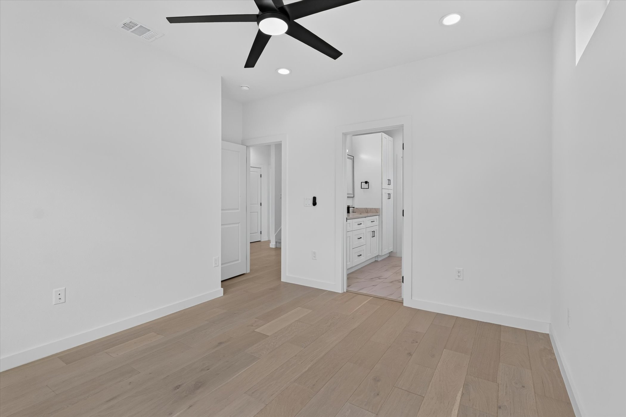 5305 Ledesma Road, Unit 1 Austin, TX 78721 - Photo 21 of 37 Smooth wood floors and crisp white walls define this airy, light-filled bedroom suite.
