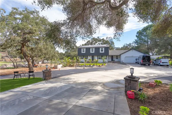 a view of house with outdoor space and swimming pool