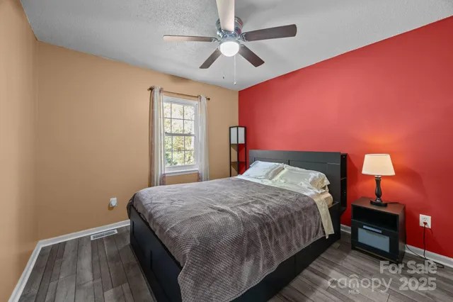 a bathroom with a granite countertop toilet sink and mirror