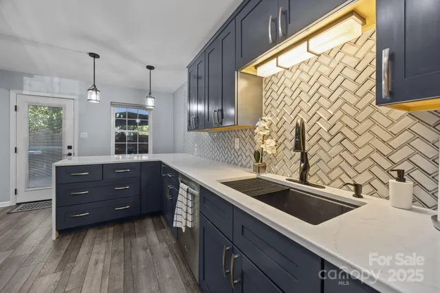 a kitchen with granite countertop a sink and a stove top oven