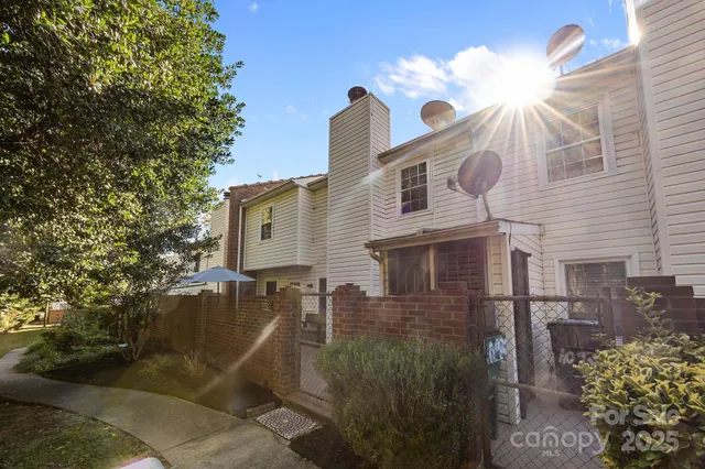 a view of a house with a small yard and plants