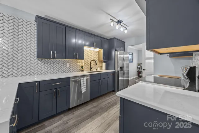 a kitchen with granite countertop a stove and a sink