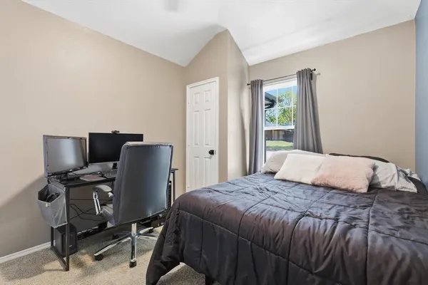 a bedroom with a bed and a desk