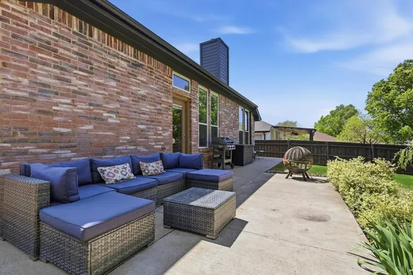 a view of a patio with couches and a potted plant