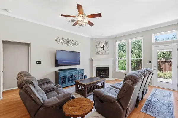 a living room with furniture a fireplace and a flat screen tv
