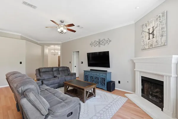 a living room with furniture a fireplace and a flat screen tv