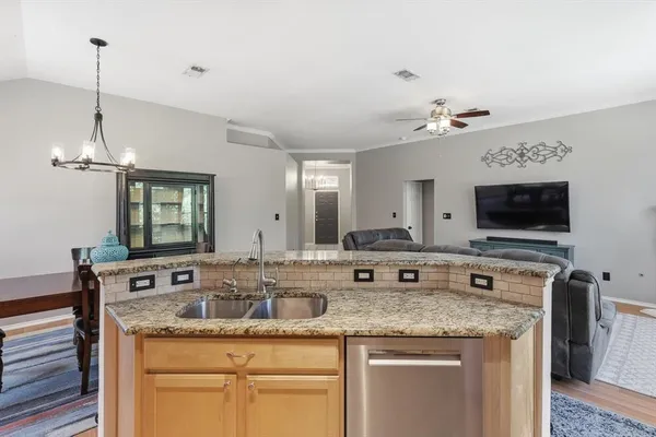 a kitchen with granite countertop a sink and a stove