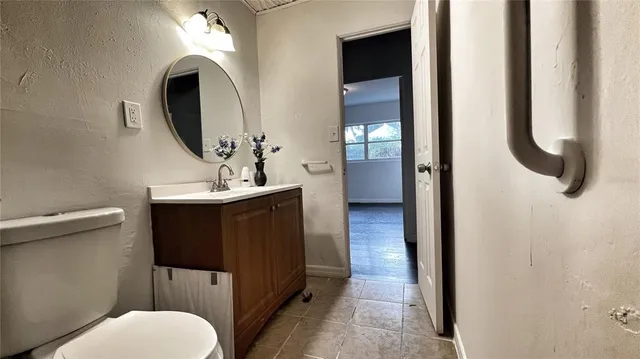 a bathroom with a toilet sink and mirror