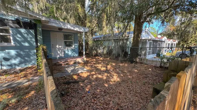 a view of a house with a tree in the yard