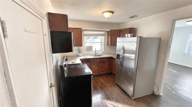 a kitchen with stainless steel appliances a refrigerator sink and stove