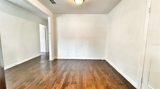a view of a room with wooden floor