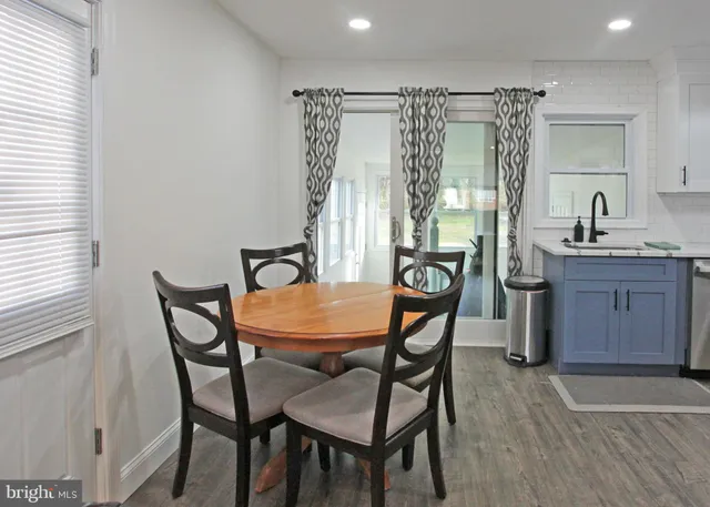 a dining room with a wooden table and chairs