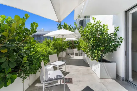 a view of a chairs and table in a patio