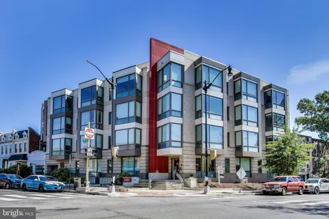 a city street lined with buildings and cars