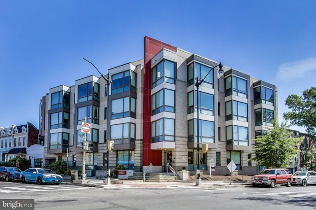 a city street lined with buildings and cars
