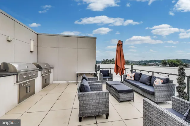 a living room with furniture a kitchen and a fireplace