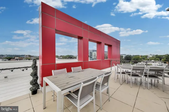 a view of a patio with table and chairs and potted plants