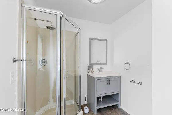 a bathroom with a sink a mirror and a shower