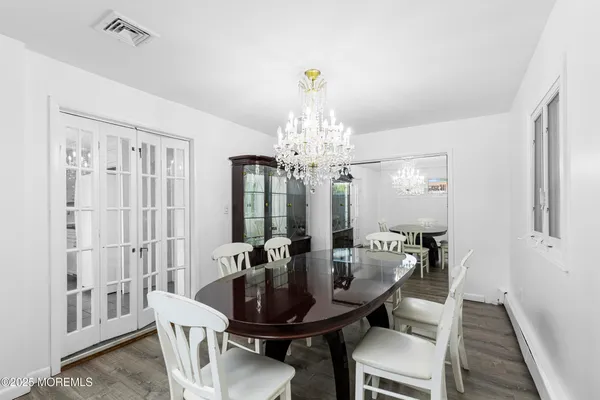 a view of a a dining room with furniture window and wooden floor