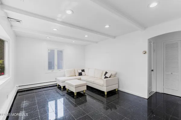 a living room with furniture and a rug
