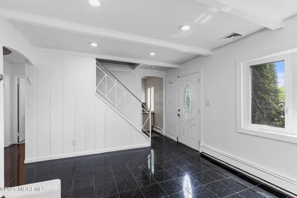 a view of entryway with stairs and wooden floor