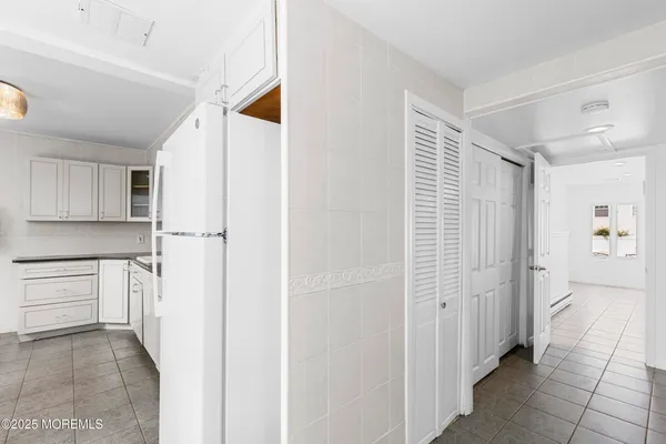 a hallway with cabinets and wooden floor
