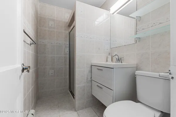 a bathroom with a toilet sink and shower
