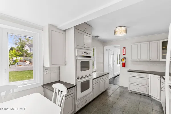 a kitchen with stainless steel appliances a white stove top oven and a refrigerator