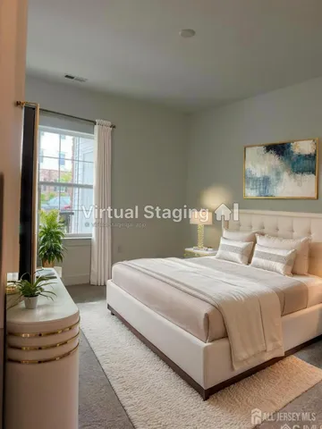 a bedroom with a large bed and a chandelier