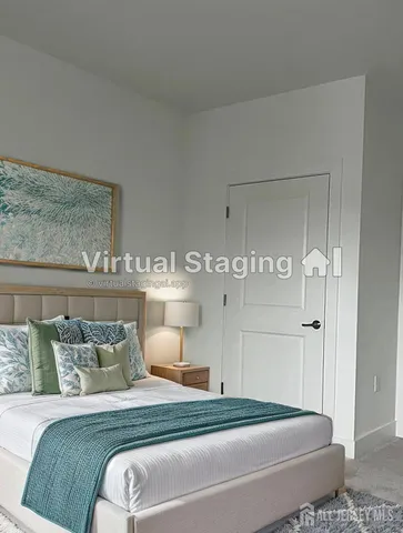 a bedroom with a bed and a mirror