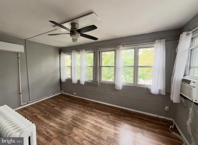 a view of room with window and a ceiling fan