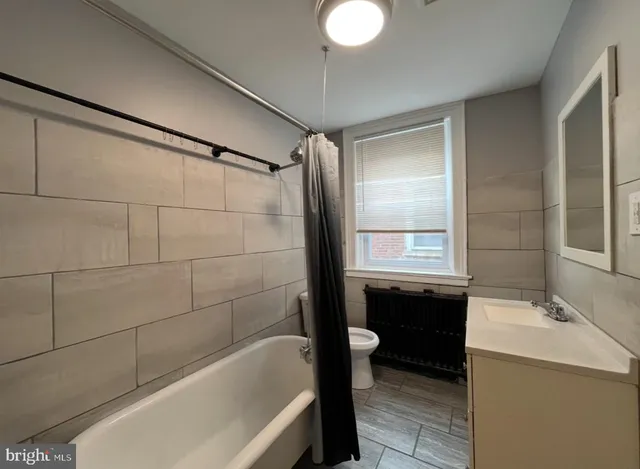 a bathroom with a bathtub a sink and a shower