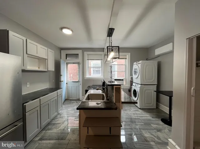 a kitchen with sink refrigerator and window
