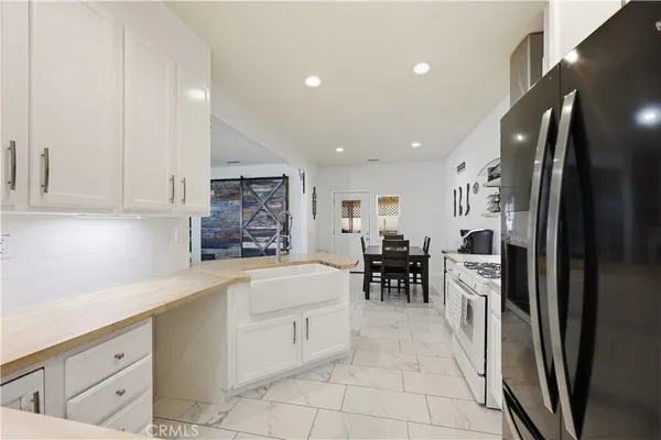 a kitchen with stainless steel appliances a refrigerator sink and cabinets