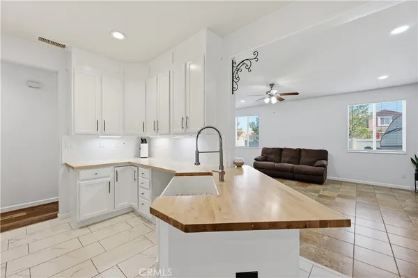a kitchen with kitchen island a sink stainless steel appliances and cabinets
