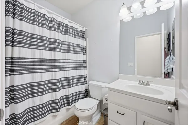a bathroom with a sink a toilet and mirror