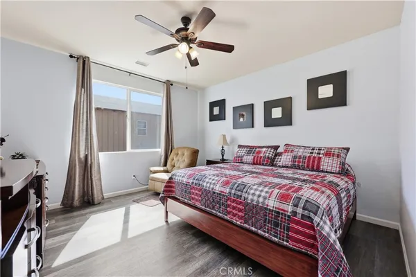 a bedroom with a large bed and a chandelier