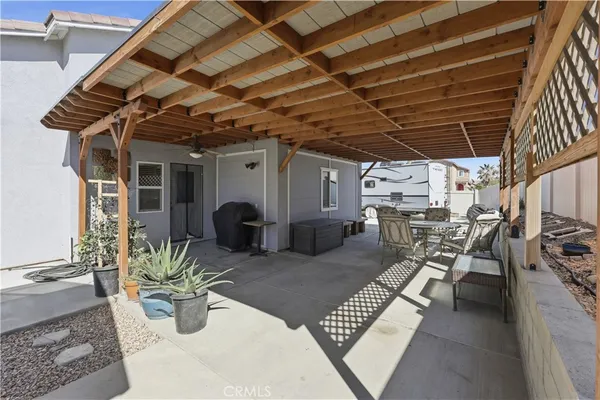 a view of a patio with table and chairs and potted plants