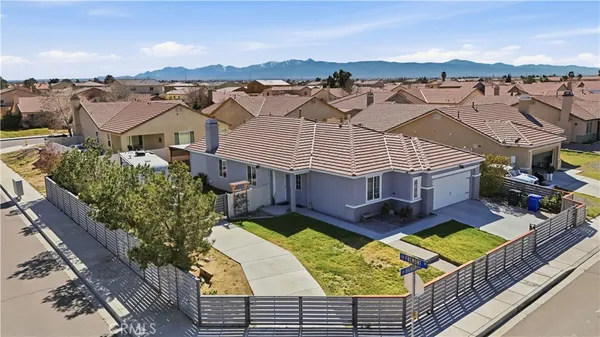 an aerial view of residential houses with yard