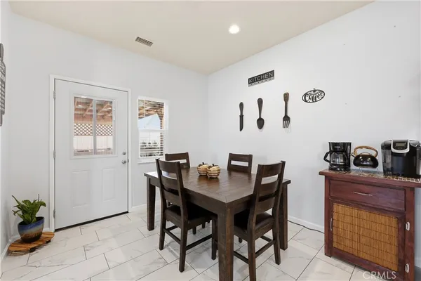 a dining room with a table and chairs