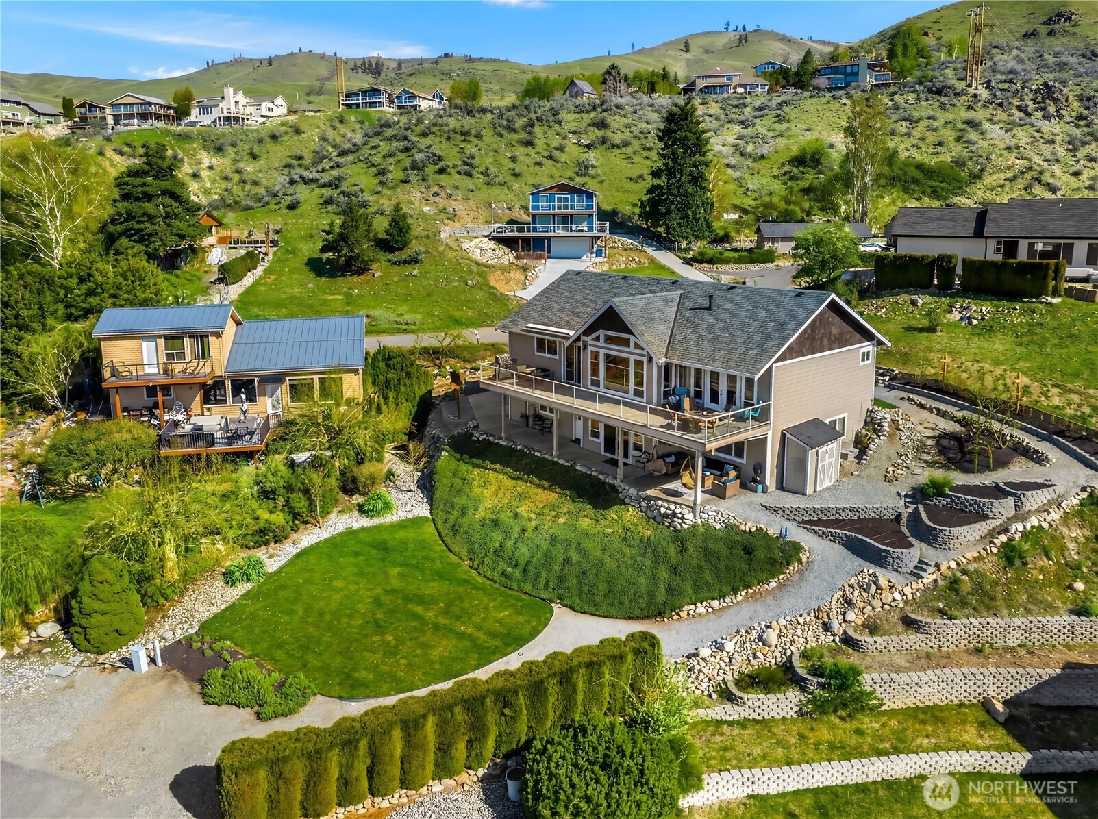 204 Stehekin Way Chelan, WA 98816 - Photo 35 of 40 an aerial view of residential houses with outdoor space and trees
