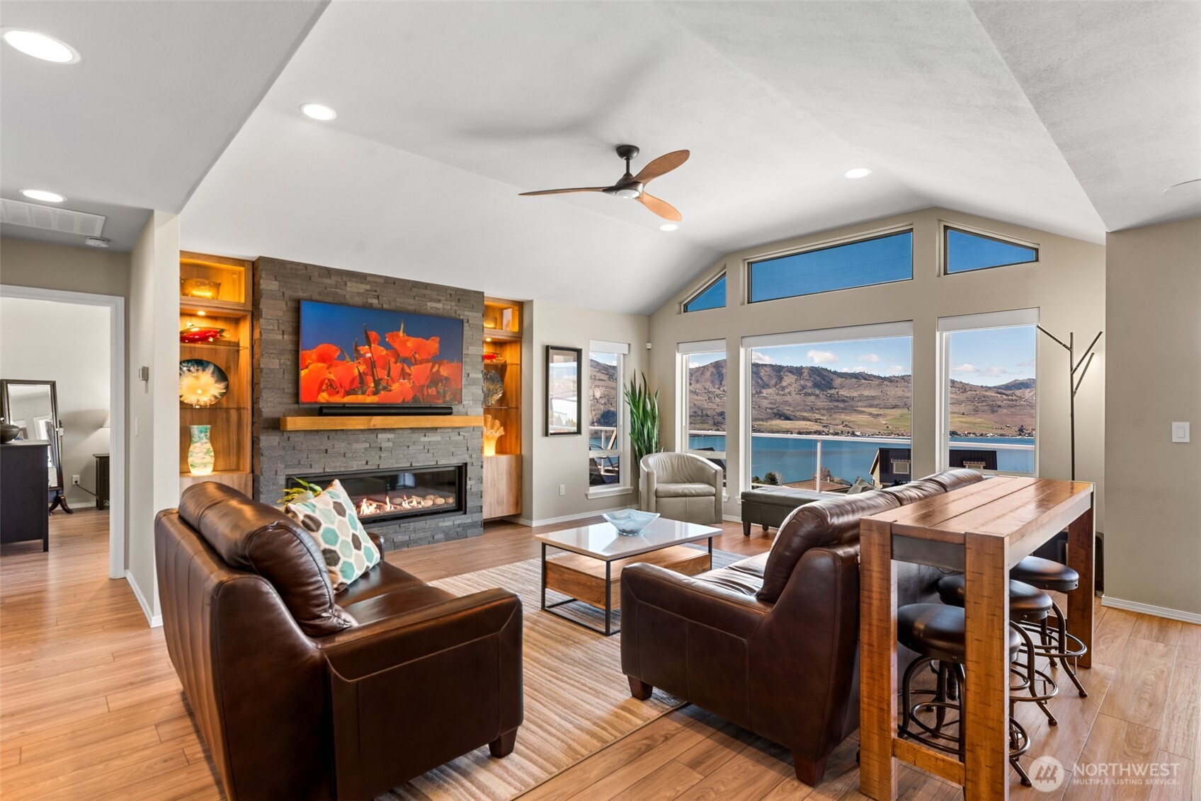 204 Stehekin Way Chelan, WA 98816 - Photo 9 of 40 a living room with fireplace furniture and a flat screen tv