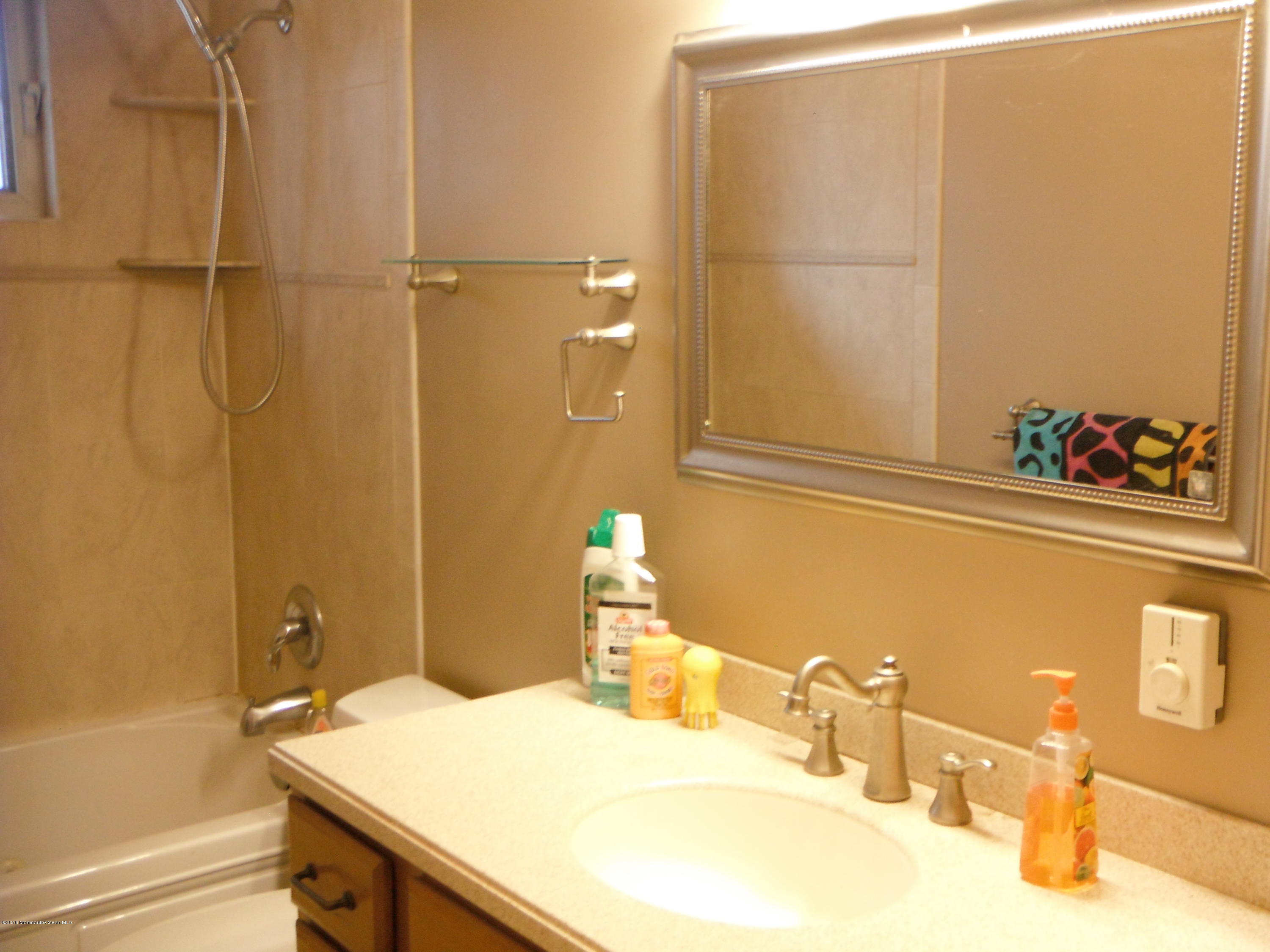 137 Gunwale Road Manahawkin, NJ 08050 - Photo 7 of 9 a bathroom with a sink and a mirror