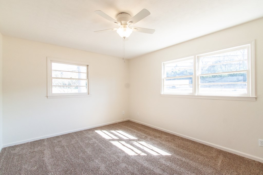 4315 Macon Road Columbus, GA 31907 - Photo 12 of 37 an empty room with windows and fan