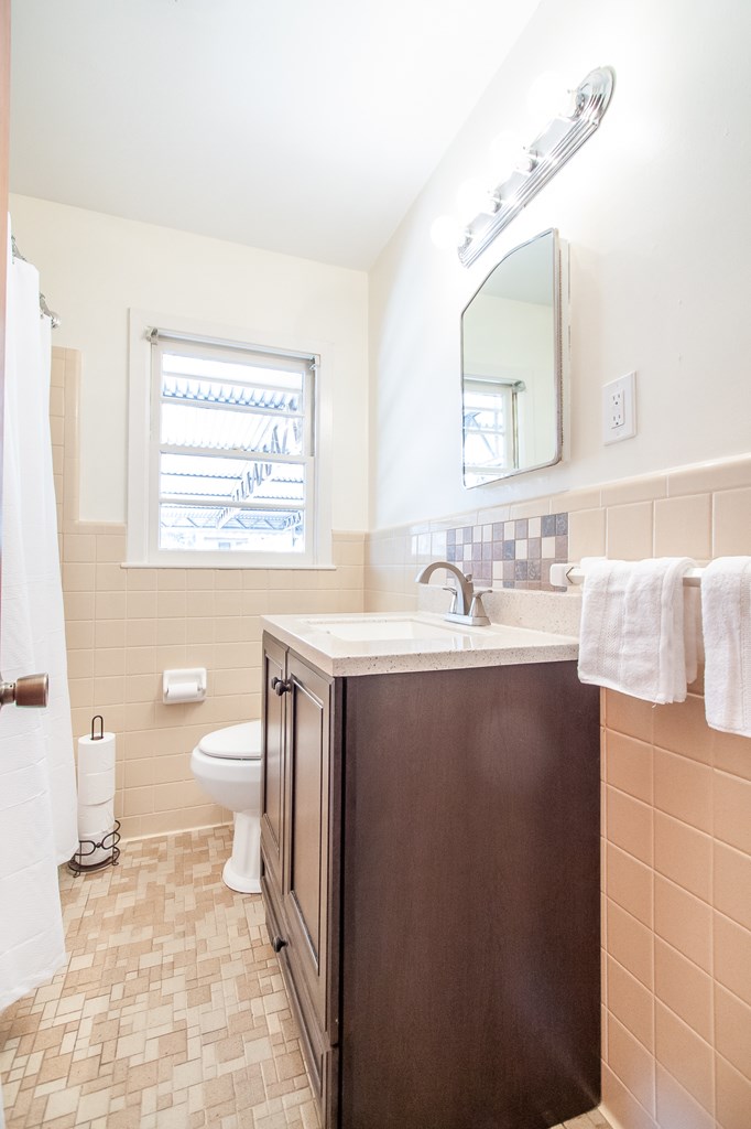 4315 Macon Road Columbus, GA 31907 - Photo 14 of 37 a bathroom with a sink a toilet and a mirror